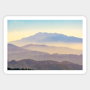 Mountain layers rising to distant peak through hazy light and different color bands. Sticker